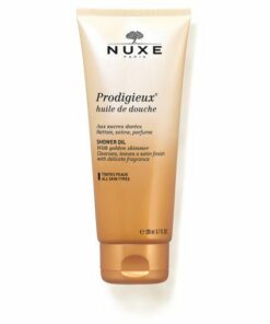 Flacon doré de l'Huile de Douche Précieuse Prodigieux Nuxe sur un fond élégant.