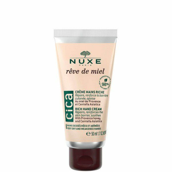 Tube doré de la Crème Mains Riche Rêve de Miel Nuxe sur un fond neutre.