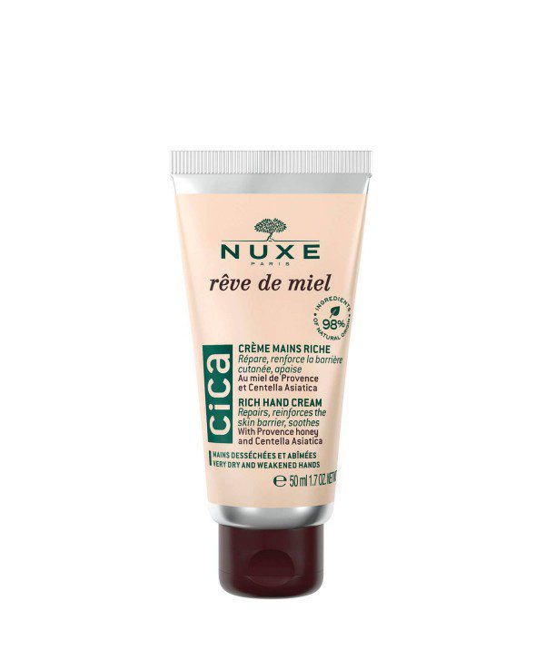 Tube doré de la Crème Mains Riche Rêve de Miel Nuxe sur un fond neutre.